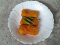 Three pieces of rissoles filled with chicken are served on a white plate.