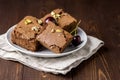 Three Pieces of Tasty Homemade Chocolate Brownies on White Plate Decorated with Cherry and Pistachios Wooden Background Homemade