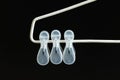 Hanging three pieces of transparent white plastic cloth clip isolated on black background Royalty Free Stock Photo