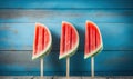 three pieces of watermelon on a stick on a wooden table Royalty Free Stock Photo