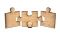 Three pieces of wooden jigsaw are connected together isolated on white background. concept of connecting