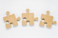 Three pieces of wooden puzzle on white background Royalty Free Stock Photo