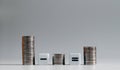 Three pile of coins with mathematical arithmetic symbols. Royalty Free Stock Photo