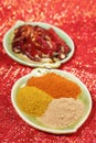 Three piles of indian powder spice on plate