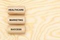 Three pillars marked with healthcare, marketing and success