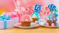 Three pink and blue novelty cupcakes decorated with candy and large lollipops. Royalty Free Stock Photo