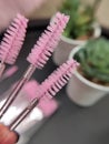 Three pink brushes for lashes and eyebrows macro view