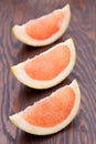 Three pink grapefruit segments