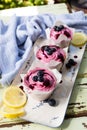 Three pink iced cupcakes with Blueberries