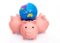 Three pink piggy banks with the globe on their back isolated against white background Royalty Free Stock Photo