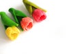 Three pink, red and yellow tulips made from soap isolated on white background. Copy space on right side Royalty Free Stock Photo