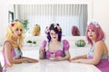 Pinup girls with colorful outfits on a table