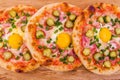 Three pizzas with ham, egg, pickled cucumber on wooden background