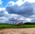 Three planes are a crop duster side view stand in a row on the green lawn of the airfield. Blue sky with big clouds Royalty Free Stock Photo