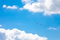 Three planes flying in the blue sky, surrounded by clouds and sunlight