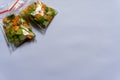 Three plastic bags of pickles made from cucumber and carrot on a white background