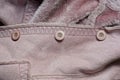 Three plastic buttons on a brown suede winter jacket