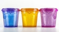 Three plastic cups with lids in different colors Royalty Free Stock Photo