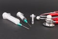 Three plastic disposable syringes and stethoscope Royalty Free Stock Photo