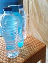 Three plastic mineral water bottles on top of an orange chair Royalty Free Stock Photo