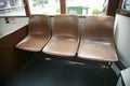 Three plastic moulded seats in a Hong Kong tram Royalty Free Stock Photo