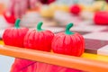 Three plastic red pumpkins in a row, perpspective view, selective focus Royalty Free Stock Photo