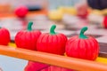 Three plastic red pumpkins in a row, perpspective view, selective focus Royalty Free Stock Photo