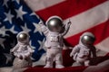 Three Plastic toys figure astronaut on American flag background Copy space. 50th Anniversary of USA Landing on The Moon Royalty Free Stock Photo