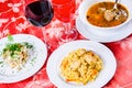 Three plates with lunch dishes on table. Salad, soup with meatballs and pilaf Royalty Free Stock Photo