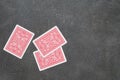 Three playing cards face down on a black table Royalty Free Stock Photo