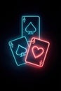Three playing cards illuminated in neon lights, featuring two aces of spades and one ace of hearts. glowing effect creates Royalty Free Stock Photo