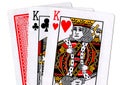 Three playing cards with a pair of kings revealed.