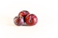 Three plums are blue on a white background Royalty Free Stock Photo