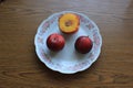 Three plums: one is slightly cut Royalty Free Stock Photo