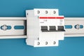 Three-pole miniature circuit breaker on the wall, 3D rendering