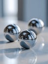 Three polished metallic spheres reflecting their surroundings placed on a smooth marble surface with soft lighting and subtle Royalty Free Stock Photo