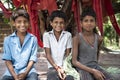 Three poor Indian boys posing for a portrait in a village in Bihar, India