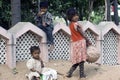 Three poor slum children playing on sand Royalty Free Stock Photo