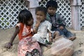 Three poor slum children playing on sand Royalty Free Stock Photo