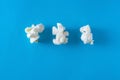 Three Popcorn on a bright blue background, design concept