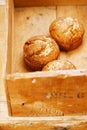 Three poppy seeds and lemon muffins in wooden box