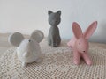 Three porcelain animal figures white mouse grey cat pink rabbit Royalty Free Stock Photo