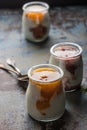 Three portions of fresh natural homemade organic yogurt in a glass jar on a vintage background