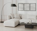 three poster frame mock up in living room interior in black and white, french style with moldings, white sofa and wall, 3d Royalty Free Stock Photo