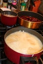 Three pots on stove cooking food for dinner