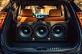 Three powerful subwoofers lying in modern car trunk Royalty Free Stock Photo