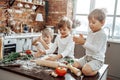 Caucasian little brothers cooking a pizza together in modern kitchen Royalty Free Stock Photo