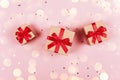 Three presents with red bow on pink