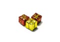 Three presents, two red and one yellow with ribbons