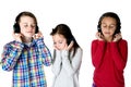 Three preteens listening to music with headphones eyes closed Royalty Free Stock Photo